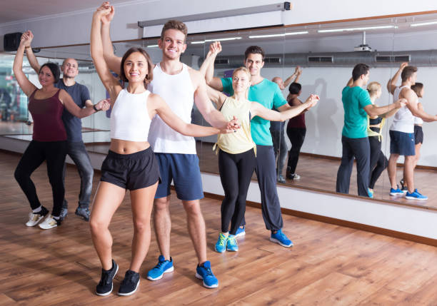 istock Group of smiling people dancing salsa together 1180392966