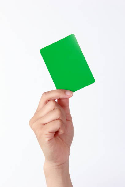 istock Woman hand holding a green card on white background 1180393082
