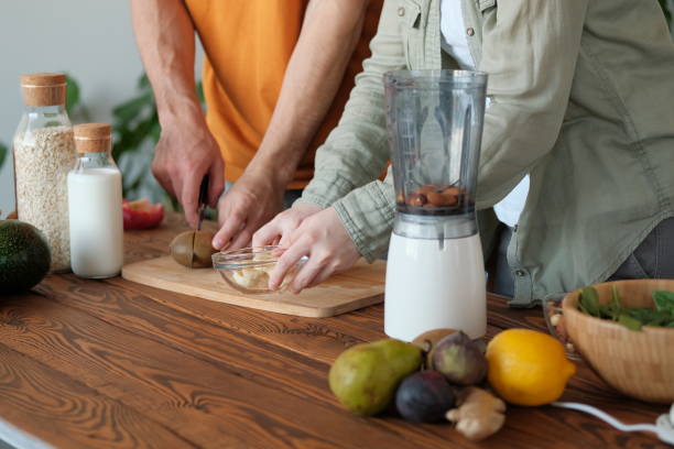 istock Young married couple is preparing a smoothie 1180393801