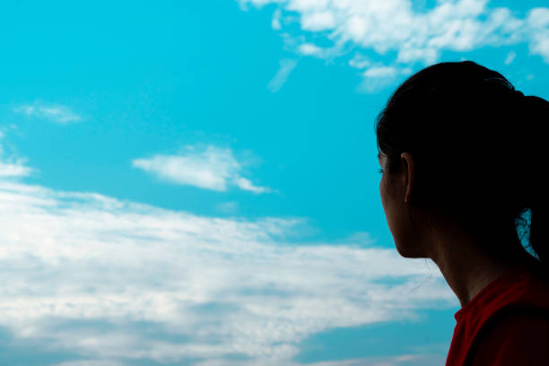 istock girl looking at the sky 1180393888