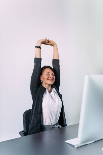 istock Satisfied young businesswoman relax stretching her hands. 1180393900
