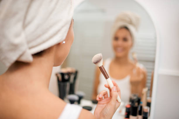 istock Applying make up with a makeup brush. Focus on the foreground, copy space. 1180393932