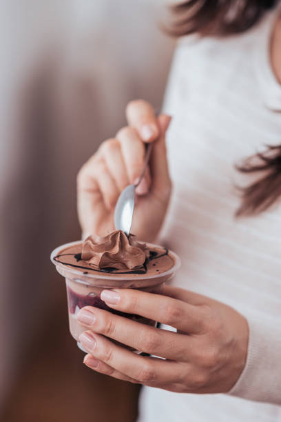 istock Girl eating chocolate dessert, close-up. 1180393975