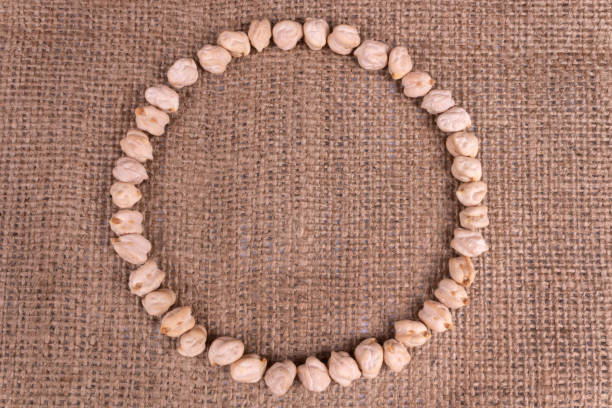 istock A composition of a circle made of chickpeas dry beans on a textured textile 1180394553