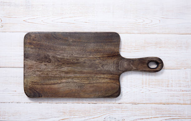 istock Cutting board on the wooden background. Top view. 1180395176