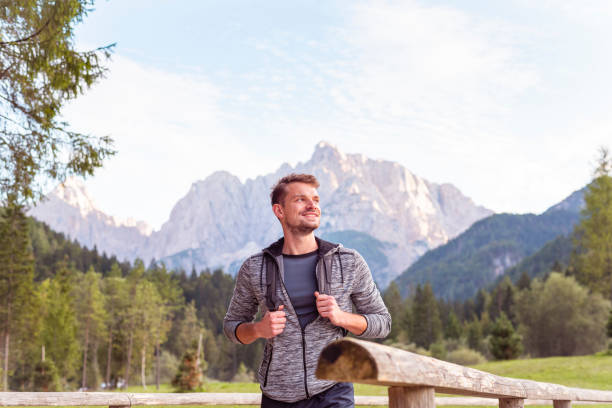 istock Young man hiking in mountains 1180395417