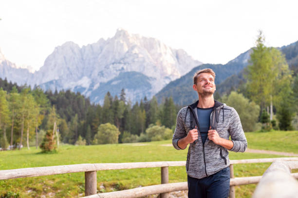 istock Young man hiking in mountains 1180395500