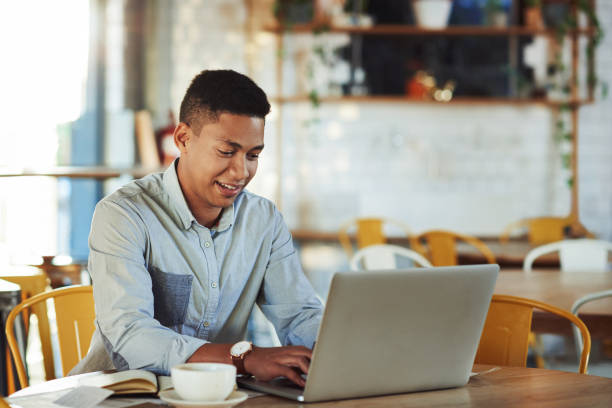 istock Updating the cafe's social media page 1180395729