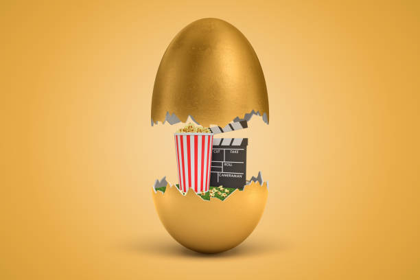 3d rendering of gold egg cracked in two, upper half levitating in air, popcorn bucket and clapperboard on green grass in lower half.