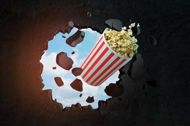 istock 3d rendering of popcorn bucket breaking black wall 1180398403