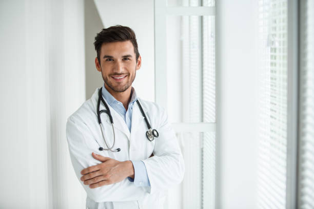 istock Confident young male doctor 1180399331