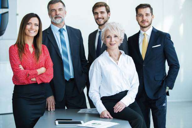 istock group of businesspeople standing together in office. 1180400885