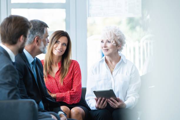 istock Team of professionals having casual discussion in office. 1180401524