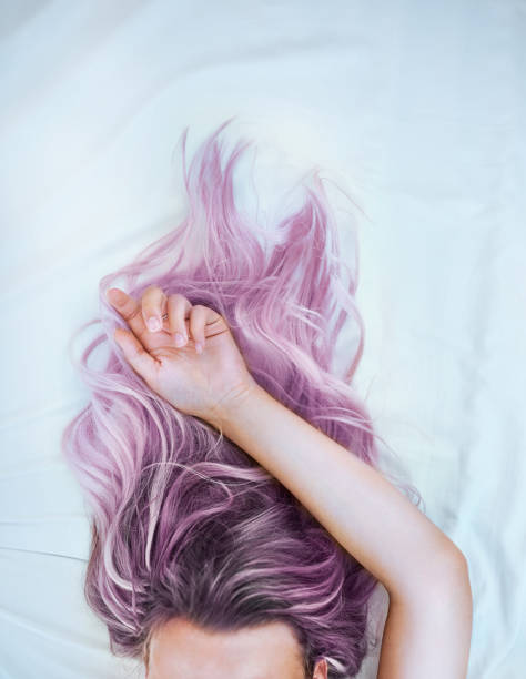 Dye your hair and live with no regrets Cropped shot of an attractive young woman lying in bed with her colorful hair purple hair stock pictures, royalty-free photos & images