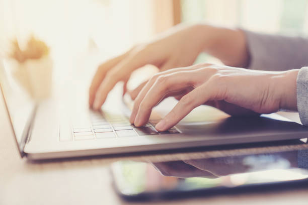 istock Business woman hand typing laptop computer on wooden table 1180402076