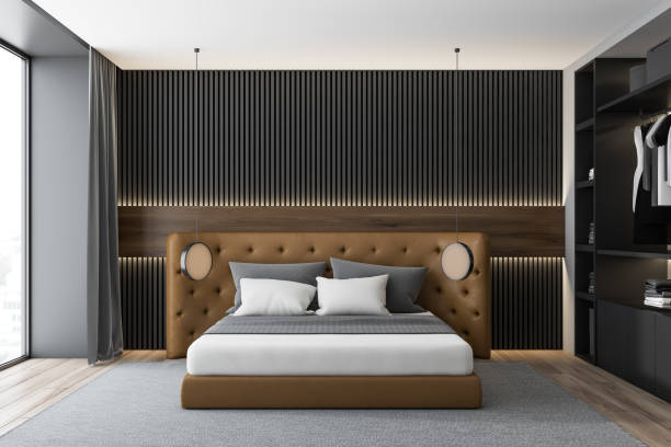 istock Dark wooden and gray bedroom with leather bed 1180403109