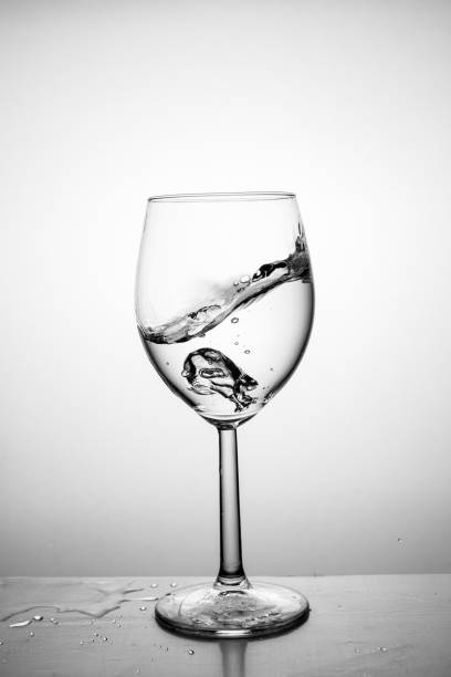 istock Glass with water up and splash. 1180404496