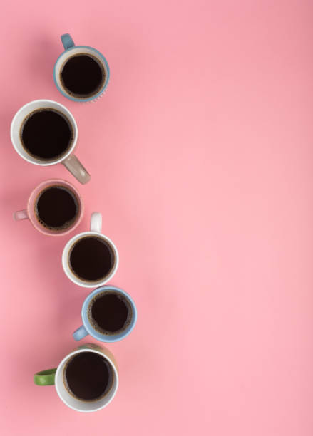 istock Coffee in the different cups on the pink background. Flatlay, cheerful day concept, vertical orientation 1180404553