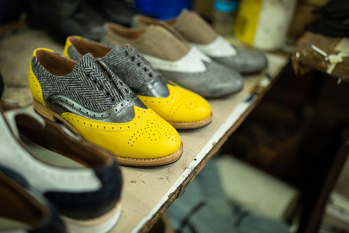 Models of modern, leather  oxford shoes in factory, close up