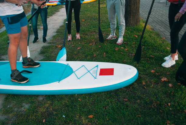istock Board paddle instructing closeup. training people on water safety, 1180406065