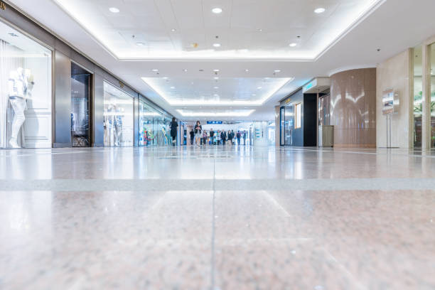 Huge modern malls hall with showcases of boutiques, shot in motion blur