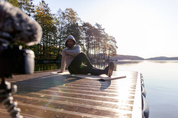 istock Man filming himself working out 1180408282