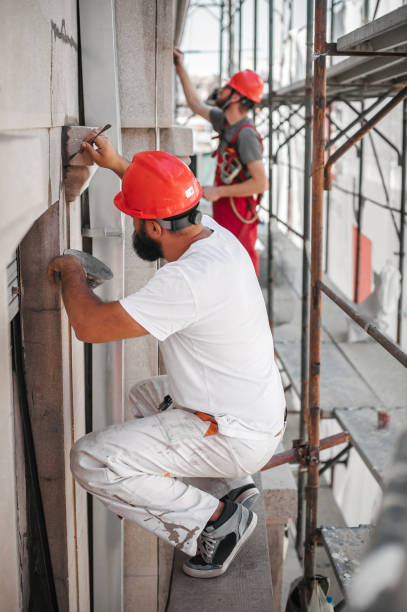 istock Two construction mason worker mixing cement and sand with spatula 1180408522