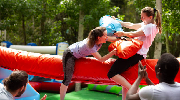 istock Pillow fight between girlfriends in an amusement park 1180408528