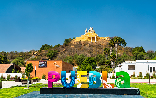 Cholula, Mexico - March 14, 2019: Sign Puebla and the Church of Our Lady of Remedies