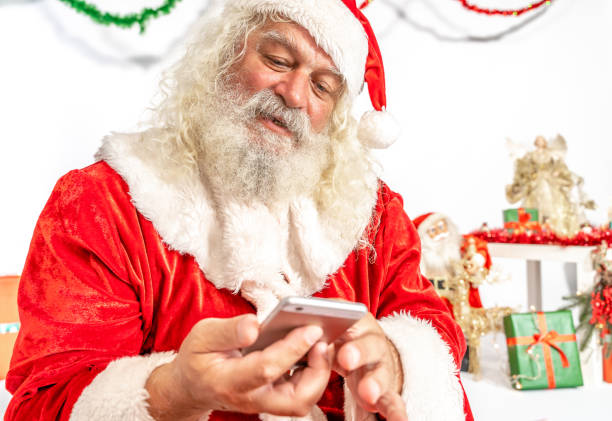 istock Santa Claus using mobile phone 1180411489