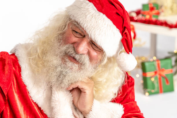istock Santa Claus make faces in front his smart phone camera, close-up 1180411623