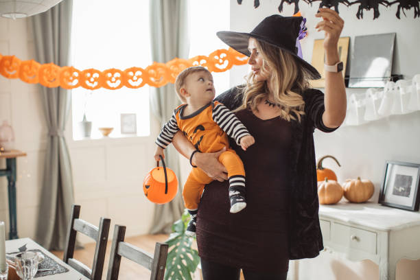 istock Decorating home for Halloween with baby 1180411994