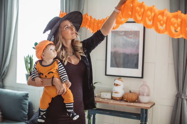 istock Decorating home for Halloween with baby 1180412043