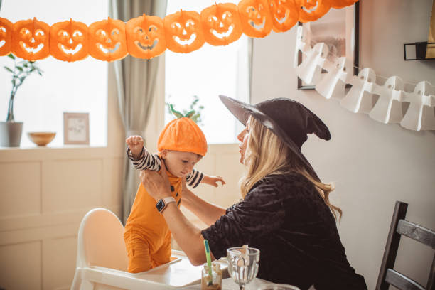 istock Mother feeding baby on Halloween 1180412725