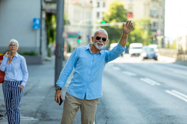 istock Senior Business Person is Calling a Cab 1180412844