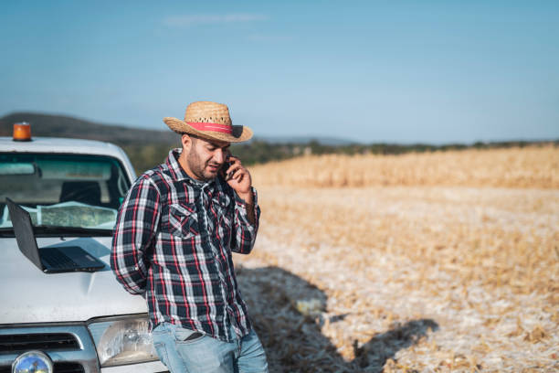 istock Farmer manage harvesting on field. 1180412876