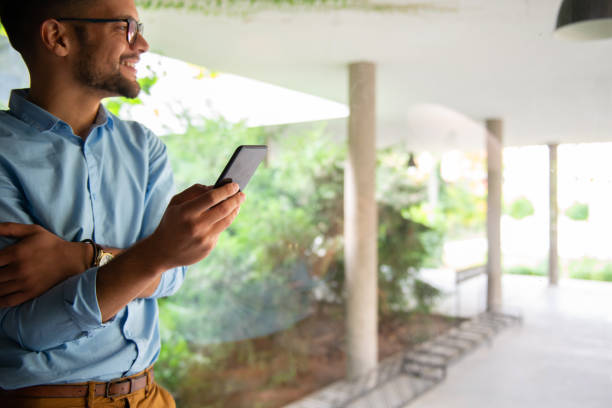 istock Young man typing on mobile phone 1180414455
