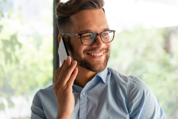 istock Smiling man talking on mobile phone 1180414533