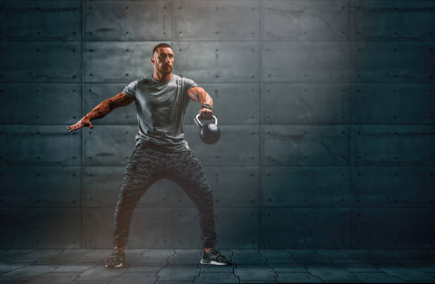 Strong Muscular Men, Cross Training Athlete Exercise With Kettlebell. Copy Space