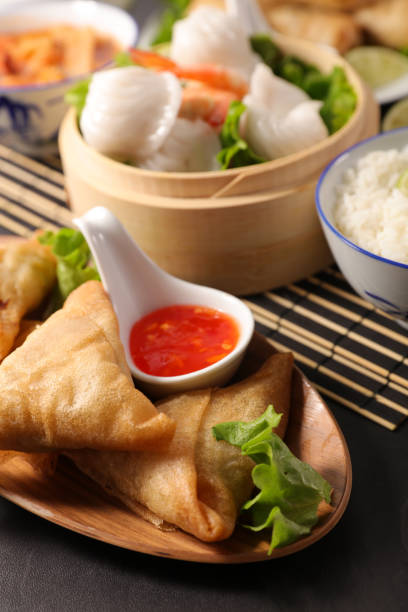 istock asian food with samosa, dumpling, spring roll and sauce 1180416956