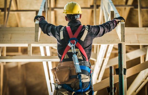 House Construction Challange Wood House Construction Challange. Caucasian Carpenter Contractor Wearing Safety Harness in Front of New Developed wood Frame Home. Construction Industry. safety harness photos stock pictures, royalty-free photos & images
