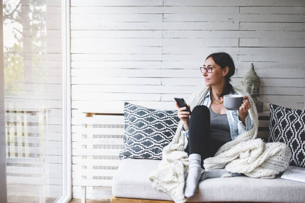 istock Middle-aged woman siting comfortable and enjoys tea 1180422569
