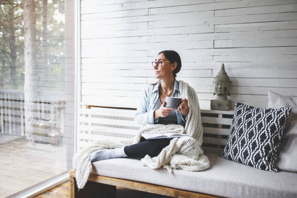 Middle-aged woman siting comfortable and enjoys tea