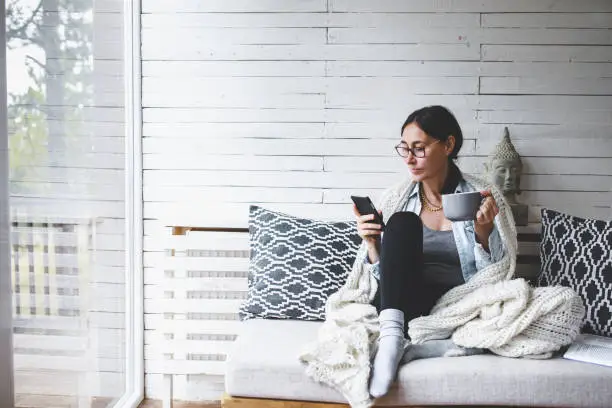 Photo of Middle-aged woman siting comfortable and enjoys tea