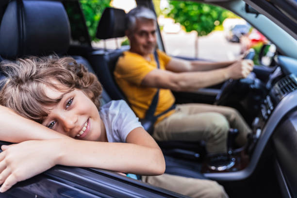 istock Happy Caucasian cute boy travelling by car 1180424204