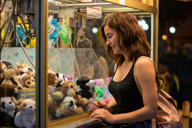 istock Young woman is playing a game in a fair 1180425446