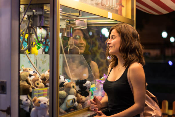 istock Young woman is playing a game in a fair 1180425469