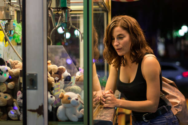 istock Young woman is playing a game in a fair 1180425481