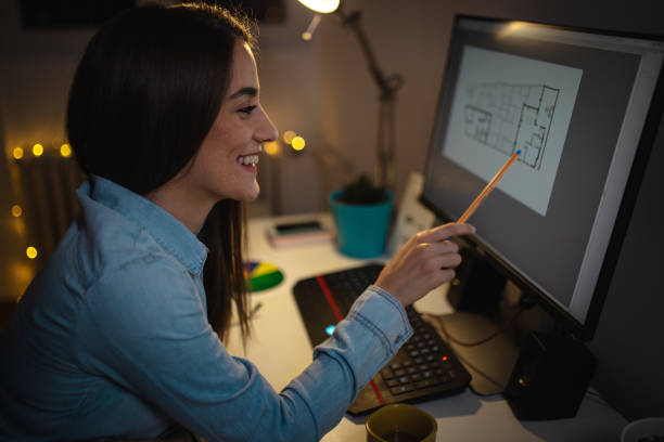 istock Young architect looking at the apartment sketch on computer 1180427051