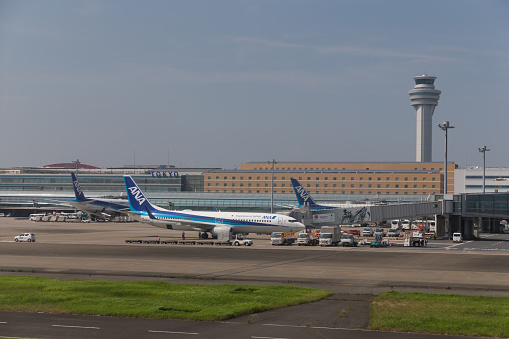 Tokyo, Japan - August 17, 2019 : Airplanes at Tokyo International Airport (Haneda Airport) in Japan. It is located in Ota Ward, Tokyo, Japan. Tokyo International Airport is the busiest airport in Japan.